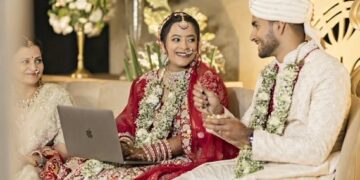 Bride Works on Laptop at Wedding