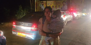 woman police constable wins praise after clearing traffic in samarlakota while holding her child in andhra pradesh Lady constable traffic video goes viral in Samarlakota Andhra Pradesh