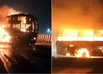 a private travels bus caught fire on kovvur flyover in ap due to short circuit. alert driver saved all passengers.