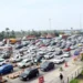 sankranti 2026 travel rush causes massive traffic jam on hyderabad vijayawada highway as vehicles line up for hours.