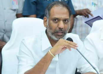 Devotees at a brightly lit temple during Maha Sivaratri festival