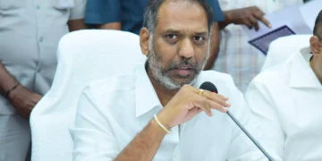 Devotees at a brightly lit temple during Maha Sivaratri festival