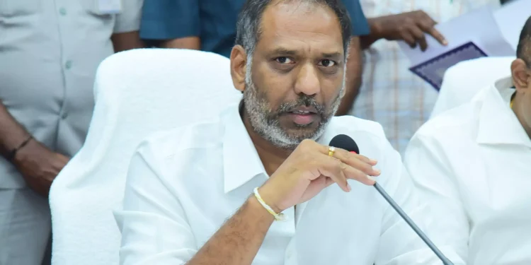 Devotees at a brightly lit temple during Maha Sivaratri festival