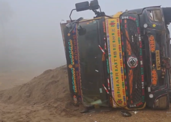 Overturned lorry after fog-related accident in Rajavommangi mandal