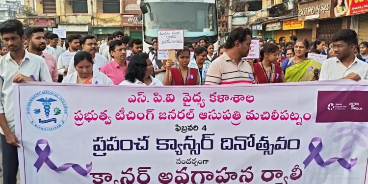 Students and officials holding banners during Krishna district cancer awareness rally